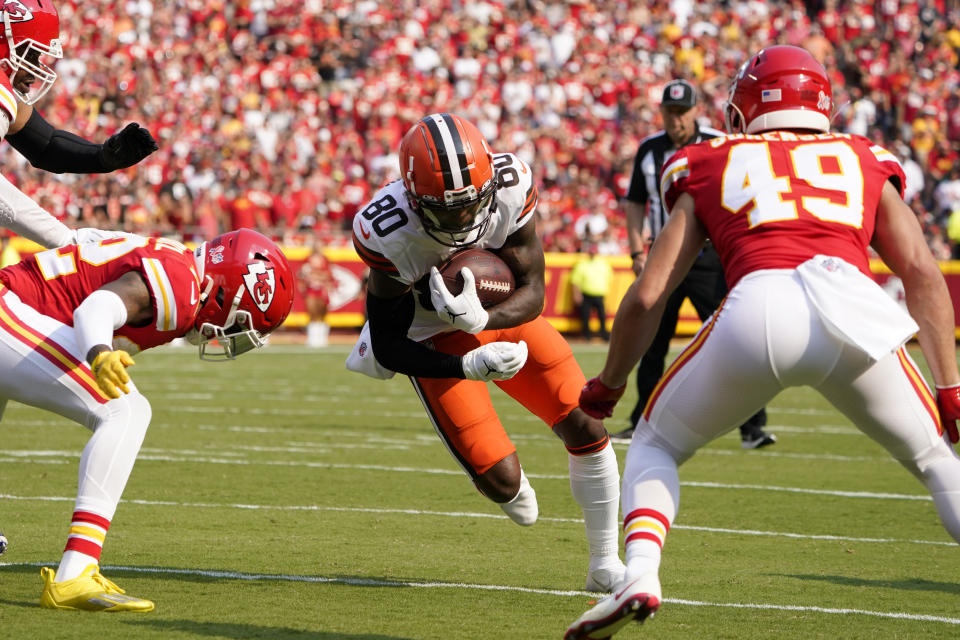 Cleveland Browns wide receiver Jarvis Landry (80) runs for a touchdown between Kansas City Chiefs safety Juan Thornhill, left, and safety Daniel Sorensen (49) during the first half of an NFL football game against the Kansas City Chiefs Sunday, Sept. 12, 2021, in Kansas City, Mo. (AP Photo/Ed Zurga)