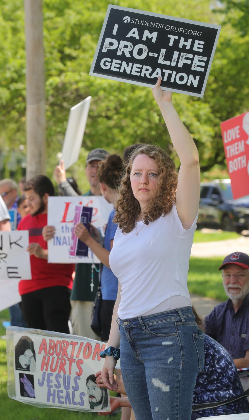 Allie Frazier, executive director of Right to Life of Northeast Ohio, stands with demonstrators at Croghan Park in Fairlawn.