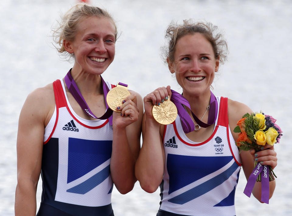 Gold medallists Katherine Copeland (L) and Sophie Hosking of Britain celebrate during the medal ceremony for the women's lightweight double sculls final in the rowing event during the London 2012 Olympic Games at Eton Dorney August 4, 2012. REUTERS/Jim Young (BRITAIN - Tags: SPORT ROWING OLYMPICS)