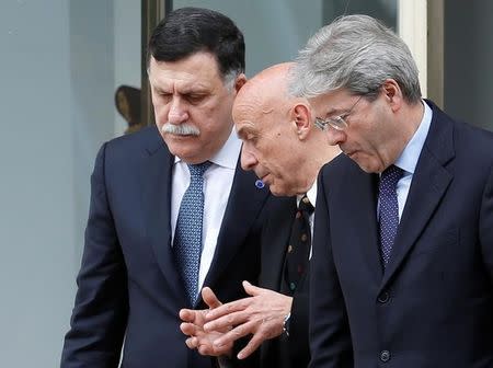 Faiez Mustafa Serraj, President of the Presidency Council of the Government of National Accord of Libya (L), talks with Italian Interior Minister Marco Minniti (C) and Prime Minister Paolo Gentiloni during a meeting in Rome, Italy March 20, 2017. REUTERS/Remo Casilli