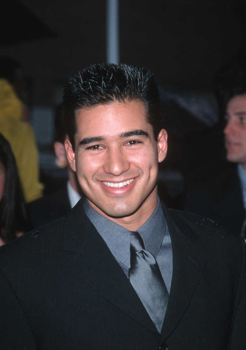 Smiling man in a formal black suit with a tie