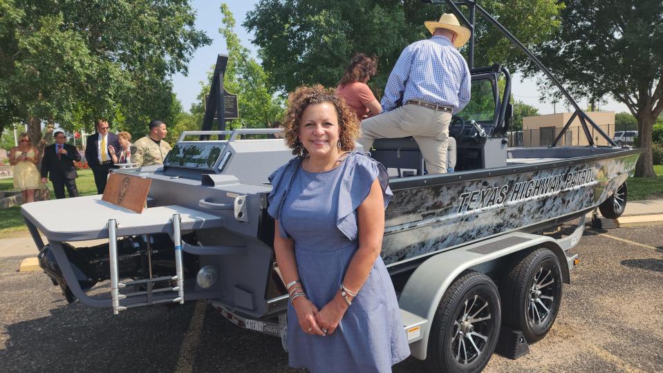 Christy Mattingly, wife of Tropper Matthew Myrick, stands beside the boat named in his honor Friday morning at the Texas Panhandle War Memorial Center in Amarillo.