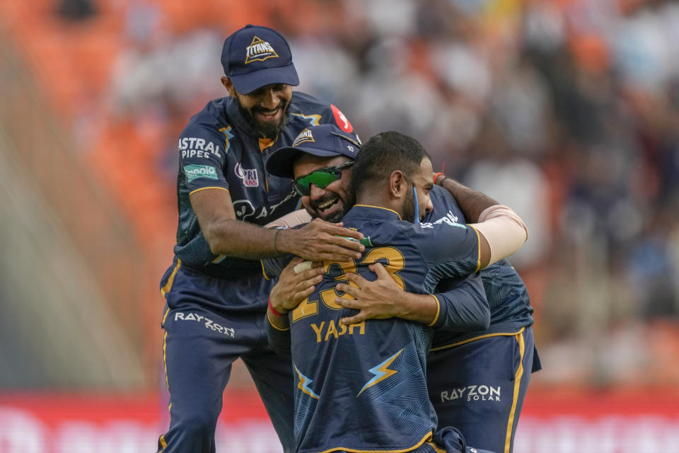 Gujarat Titan's Yash Dayal, center without cap, celebrate with his teammates the dismissal of Kolkata Knight Riders's Rahmanullah Gurbaz during the Indian Premier League (IPL) match between Gujarat Titans and Kolkata Knight Riders in Ahmedabad, India, Sunday, April 9, 2023. (AP Photo/Ajit Solanki)