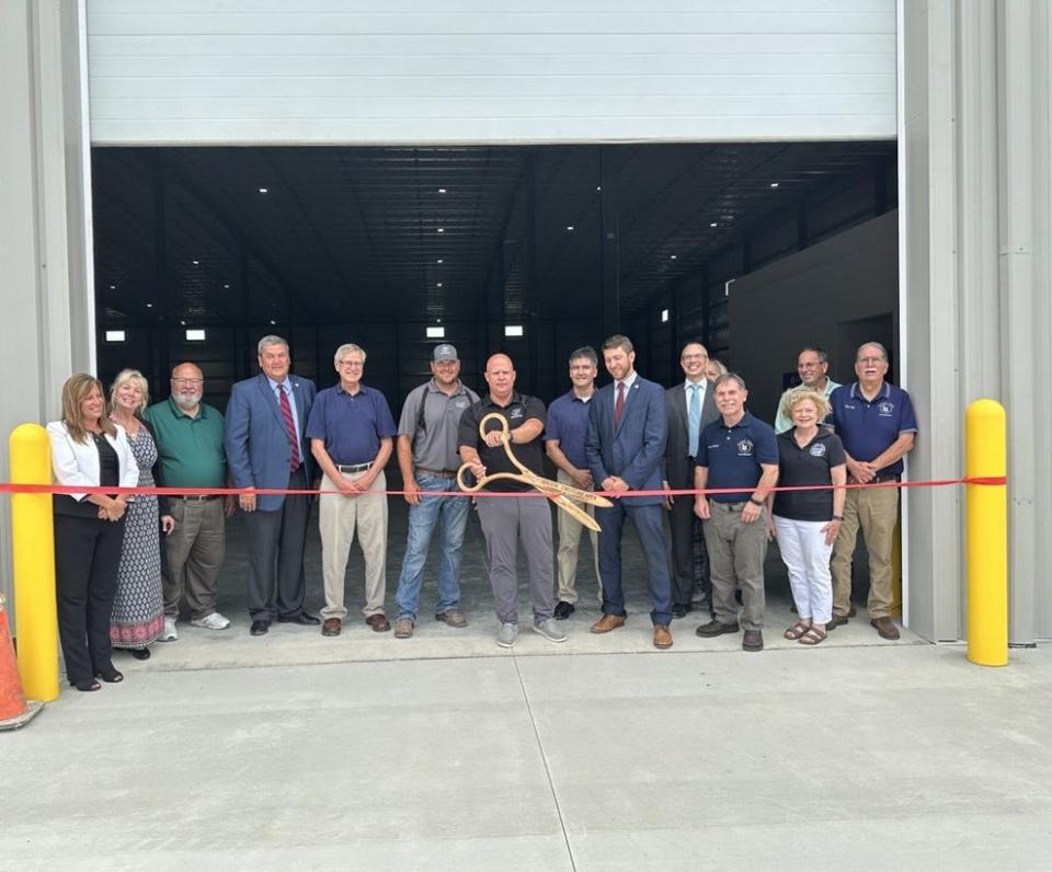 A ribbon cutting ceremony was held to celebrate a new 50,000 square foot facility in the Galion Industrial Park. Taking part in the ceremony were (left to right) Kim Winkle, Melissa Frank-Elwell, Mark Rantala, Scott Ryan, Tom O’Leary, Brock Mayes, Steve Bridgford, Gary Frankhouse, Riordan McClain, David Zak, Larry Schmidt, Lu Cooke, Doug Weisenauer and Tim Ley.