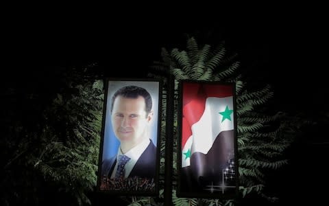 A picture of Syrian President Bashar al-Assad is seen at a train station in Damascus, Syria, September 12, 2018. - Credit: &nbsp;Marko Djurica/Reuters