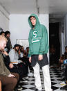 In this Friday, Sept. 13, 2019 photo provided by Bstroy, models at a show for fashion brand Bstroy wear hoodies emblazoned with the names of schools touched by mass shootings, at an apartment in the Soho neighborhood of Manhattan in New York. The hoodies have created a backlash from critics who say they glamorize violence and aim to profit from tragedy. Bstroy co-founder Dieter Grams says the hoodies are an effort to bring attention to gun violence and are not for retail sale. (Bstroy via AP)