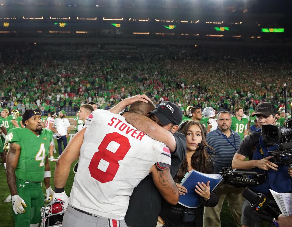 Sep 23, 2023; South Bend, Indiana, USA; Ohio State Buckeyes head coach Ryan Day hugs tight end Cade Stover (8) after beating Notre Dame Fighting Irish 17-14 at Notre Dame Stadium.