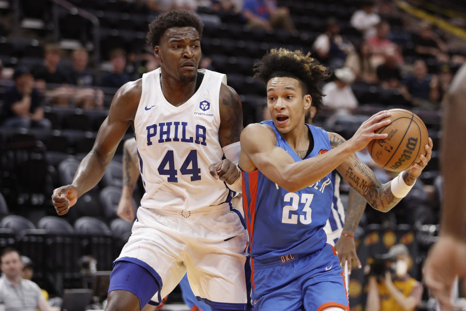 Oklahoma City Thunder guard Tre Mann (23) drives against Philadelphia 76ers forward Paul Reed Jr. (44) during the first half of an NBA summer league basketball game Thursday, July 7, 2022, in Salt Lake City. (AP Photo/Jeff Swinger)