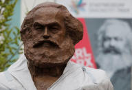 FILE PHOTO: Workers set up a bronze sculpture of Karl Marx in his hometown Trier, Germany, April 13, 2018. REUTERS/Wolfgang Rattay/File Photo