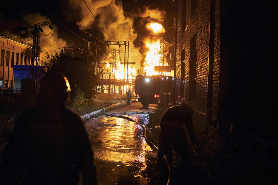 Ukrainian State Emergency Service firefighters put out the fire after a Russian rocket attack hit an electric power station in Kharkiv, Ukraine, Sunday, Sept. 11, 2022. The Kharkiv and Donetsk regions have been completely de-energised in the rocket attack. (AP Photo/Kostiantyn Liberov)