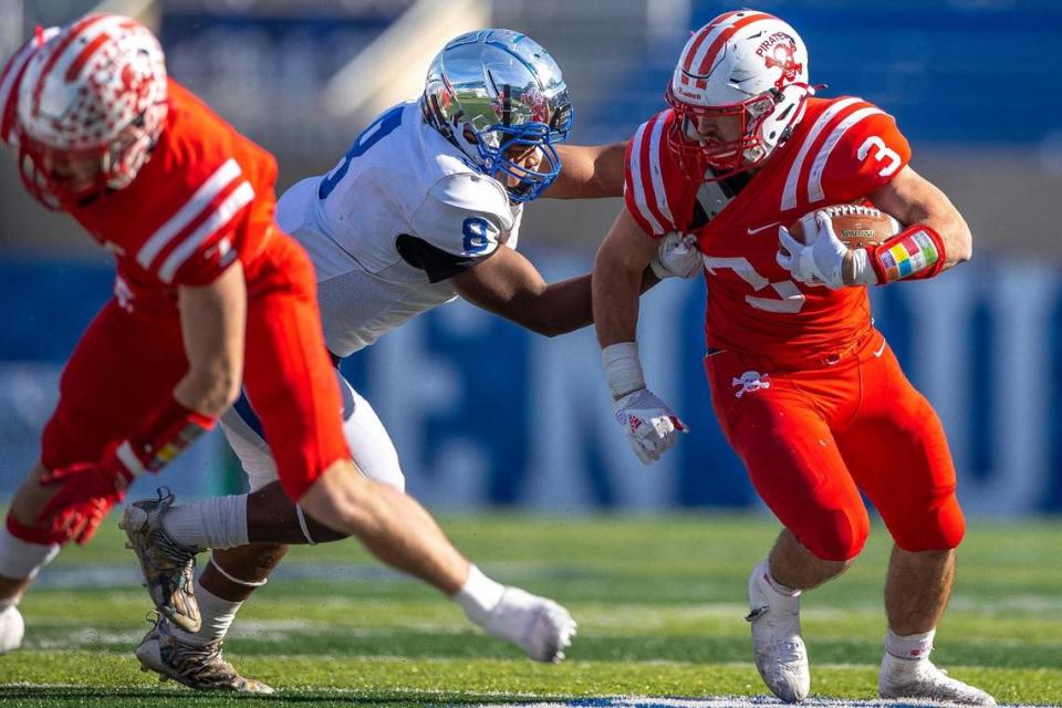 Belfry’s Isaac Dixon (3) tries to escape Paducah Tilghman’s Chris Allen (8) on Saturday. Dixon rushed for 376 yards and five touchdowns.