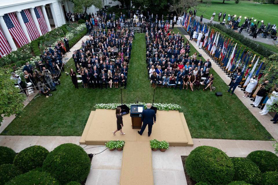 Judge Amy Coney Barrett walks to the microphone after President Donald Trump, right, announced Barrett as his nominee to the Supreme Court, in the Rose Garden at the White House, Saturday, Sept. 26, 2020, in Washington.