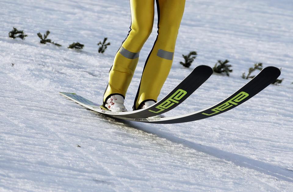 Finland's Mikke Leinonen lands on the course during the ski jumping large hill portion of the Nordic combined training at the 2014 Winter Olympics, Saturday, Feb. 15, 2014, in Krasnaya Polyana, Russia. 