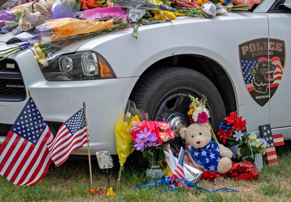 People have left items on a memorial Monday, Aug. 1, 2022 in Elwood, Ind., paying respects to Elwood Police Officer Noah Shahnavaz who was killed early Sunday morning, July 31, 2022, during a traffic stop in Madison County. 
