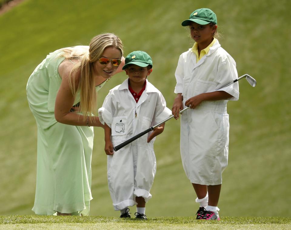 Lindsey Vonn, girlfriend of U.S. golfer Tiger Woods, speaks with Woods' son Charlie and daughter Sam (R) during the par 3 event held ahead of the 2015 Masters at Augusta National Golf Course in Augusta, Georgia April 8, 2015. REUTERS/Phil Noble