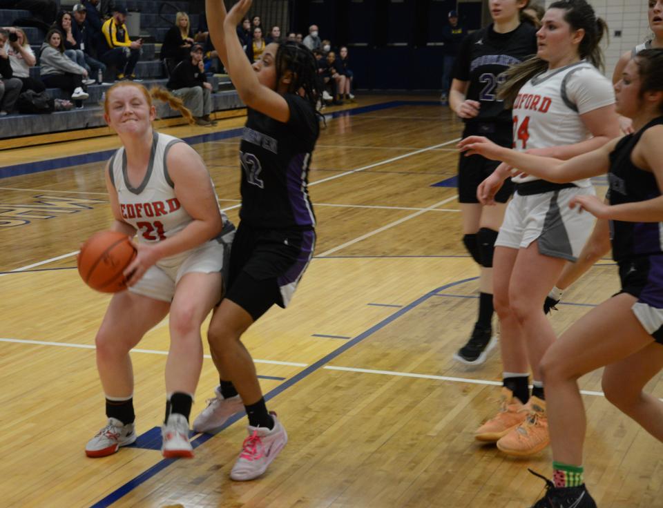 Aubrey Hensley of Bedford looks for a shot on the baseline Wednesday during a 48-27 Beford win over Woodhaven in the semifinals of the Division 1 District at Trenton.