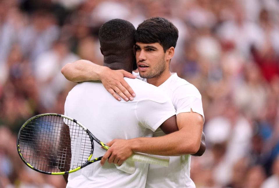 Carlos Alcaraz embraces Frances Tiafoe at the net after their match (Zac Goodwin/PA Wire)