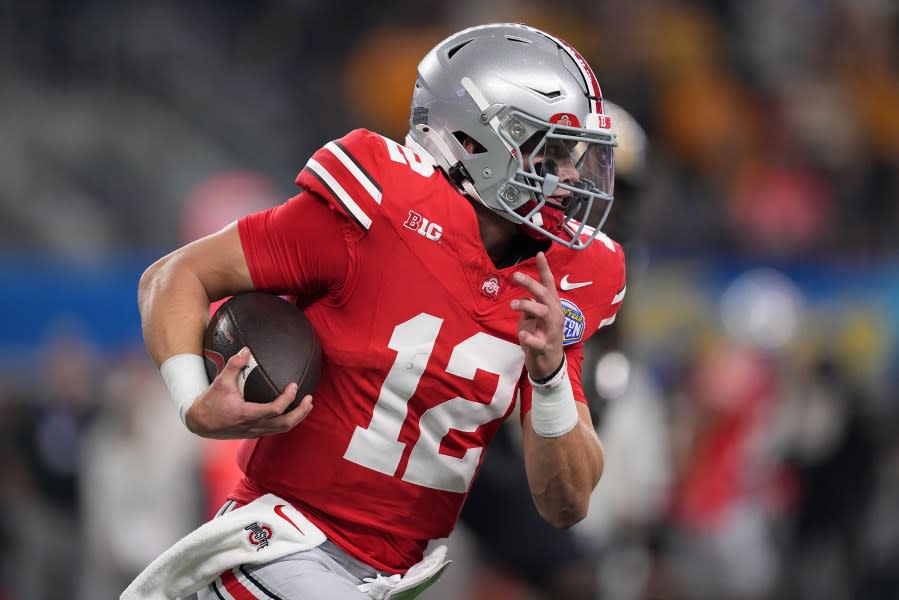 ARLINGTON, TEXAS – DECEMBER 29: Lincoln Kienholz #12 of the Ohio State Buckeyes runs the ball during the second quarter against the Missouri Tigers in the Goodyear Cotton Bowl at AT&T Stadium on December 29, 2023 in Arlington, Texas. (Photo by Sam Hodde/Getty Images)