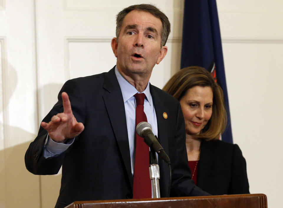 Virginia Gov. Ralph Northam, left, accompanied by his wife, Pam, speaks during a news conference in the Governor's Mansion in Richmond, Va., on Saturday, Feb. 2, 2019. Northam is under fire for a racial photo that appeared in his college yearbook. (AP Photo/Steve Helber)