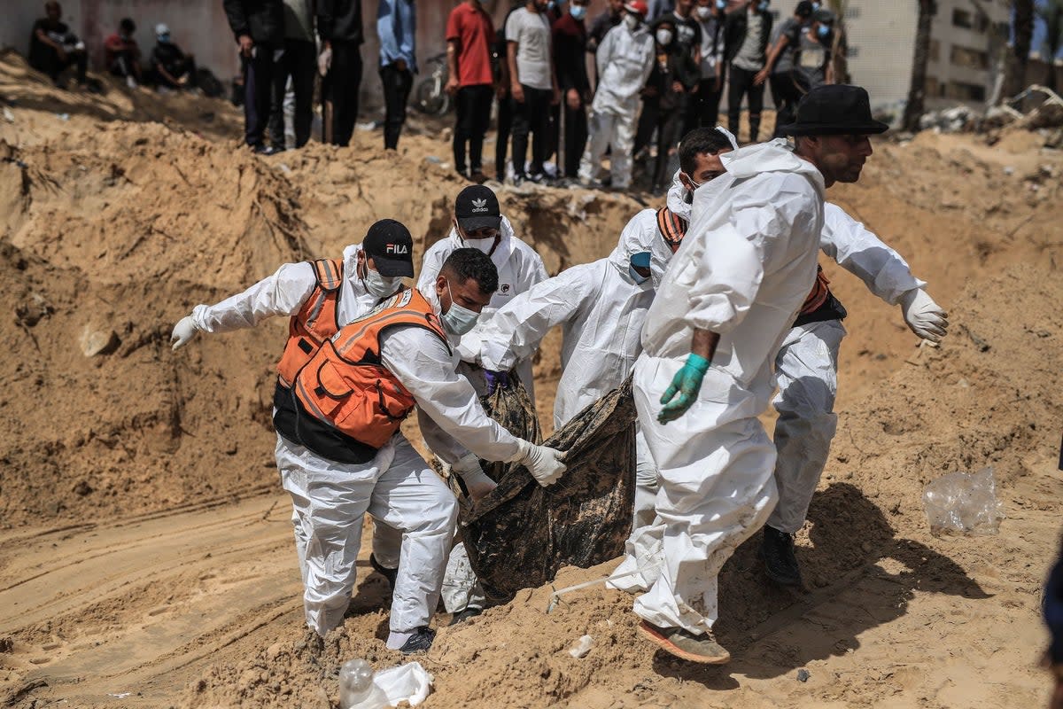 Civil Defence Authority teams continue to remove the decomposed and dismembered bodies of Palestinians from under the rubble in Khan Yunis (Anadolu via Getty Images)