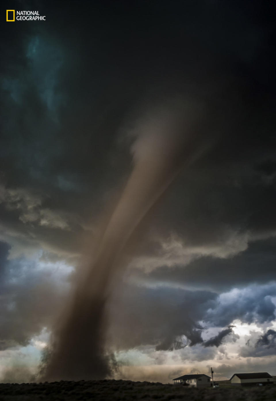 Tori Shea-Ostberg: "An EF2 tornado bears down on a home in Wray, Colorado, on May 7, 2016. As soon as we were safe, as the tornado roared off into the distance through a field before roping out, we scrambled up the hill to check on the residents. Thankfully, everyone was all right, and we were grateful for that. As I was checking in with a young woman coming out of the basement, we became very aware of a strong new circulation right above our heads. We needed to run for cover and did so before saying a proper goodbye."