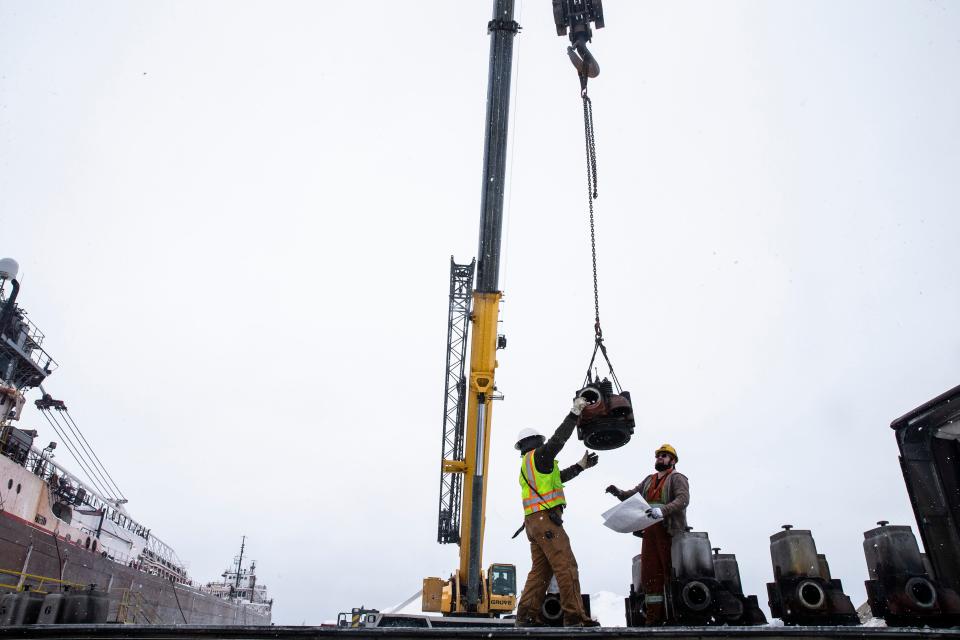 Khamza Lomidze, left, and Andrew Chamberlain unload cylinder heads on Jan. 28, 2022, at the Parade Street Dock in Erie. 