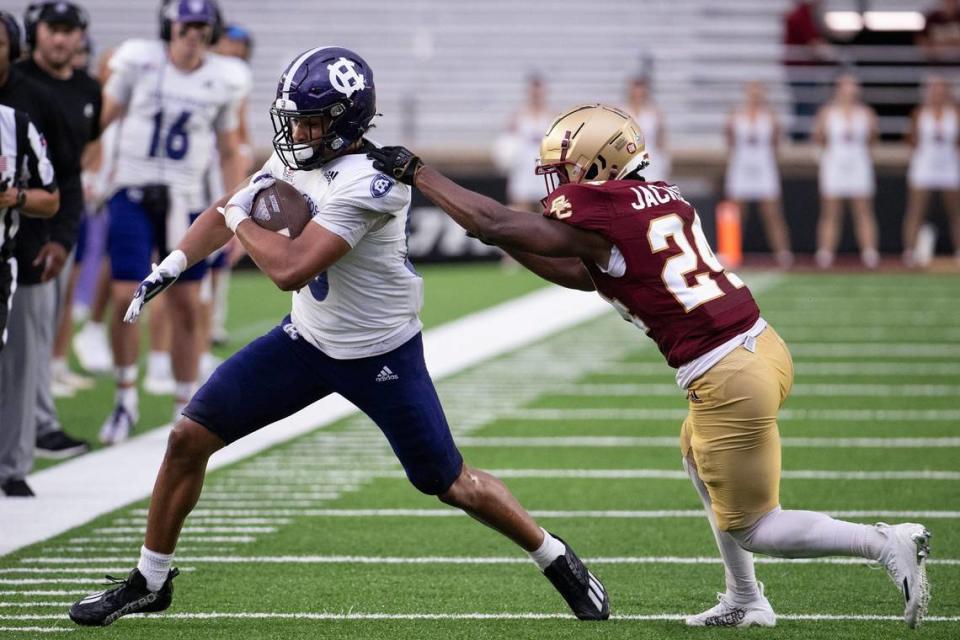 After play resumed Holy Cross’s Jalen Coker runs out of bounds while Boston College’s Amari Jackson pursues on Saturday September 9, 2023 at Alumni Stadium in Newton.