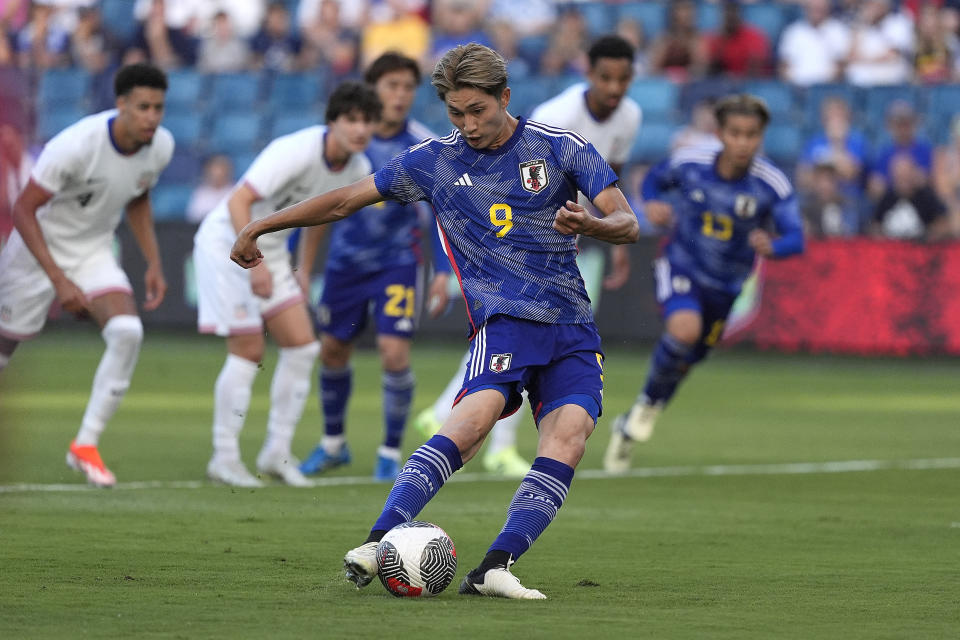 Japan forward Shota Fujio (9) kicks the ball for a goal during the first half of an international friendly under-23 soccer match against the United States Tuesday, June 11, 2024, in Kansas City, Kan. (AP Photo/Charlie Riedel)