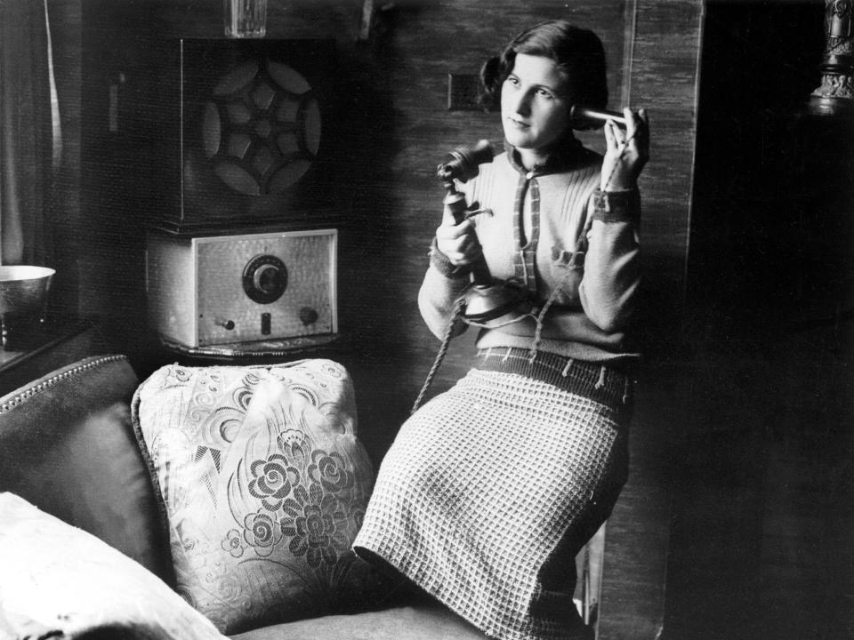woman using telephone 1920s