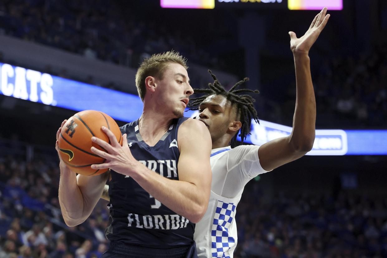 UNF's Carter Hendricksen (3) pulls down a rebound against Kentucky's Damion Collins (4) last season at Rupp Arena in Lexington, Ky.