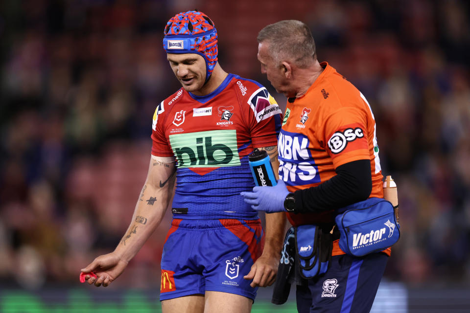 Kalyn Ponga (pictured) receives attention after a tackle.