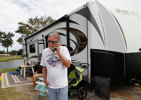Mark Shafranski of Hollywood, Florida speaks to a neighbor while riding out Hurricane Irma at their trailer at Atlanta Motor Speedway in Hampton, Georgia, U.S., September 10, 2017. REUTERS/Tami Chappell