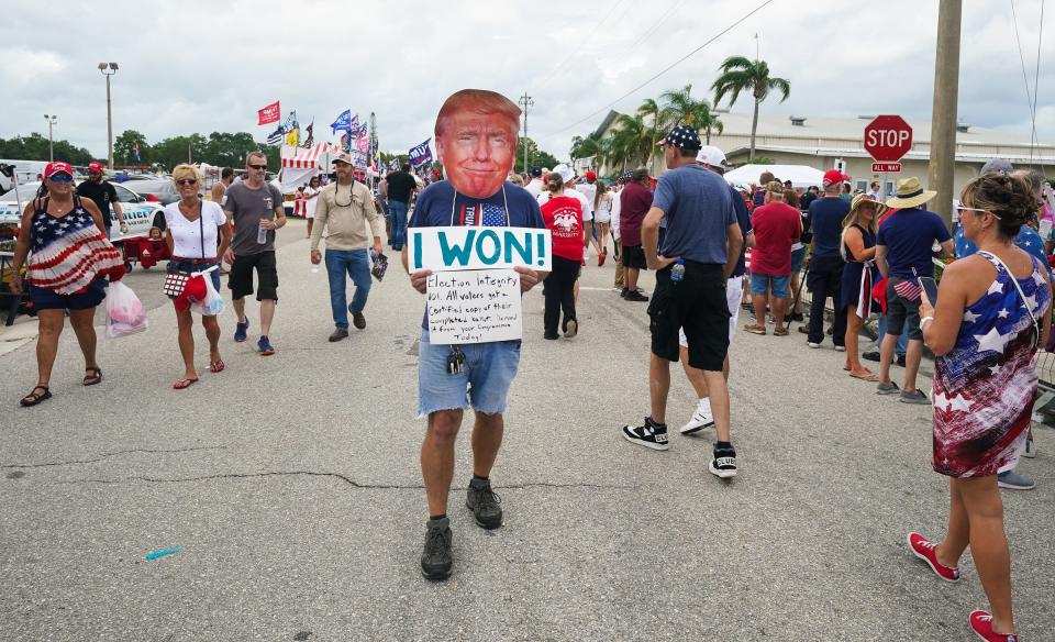 Wearing a cutout of Donald Trump's face, Marc DiMaggio of Punta Gorda attends a rally for former President Donald Trump at the Sarasota Fairgrounds on Saturday, July 3, 2021.