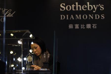 A member of staff checks a display prior to the exhibition sale of Sotheby's Diamonds during Sotheby's Beijing Art Week in Beijing, November 28, 2013. China's first full-scale Sotheby's auction of modern and contemporary Chinese art will be held on December 1st. REUTERS/Kim Kyung-Hoon