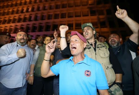 Retired soldiers chant slogans as they take part in a protest over proposed cuts to the cost of military pensions and benefits in front of the central bank in Beirut, Lebanon May 12, 2019. REUTERS/Mohamed Azakir