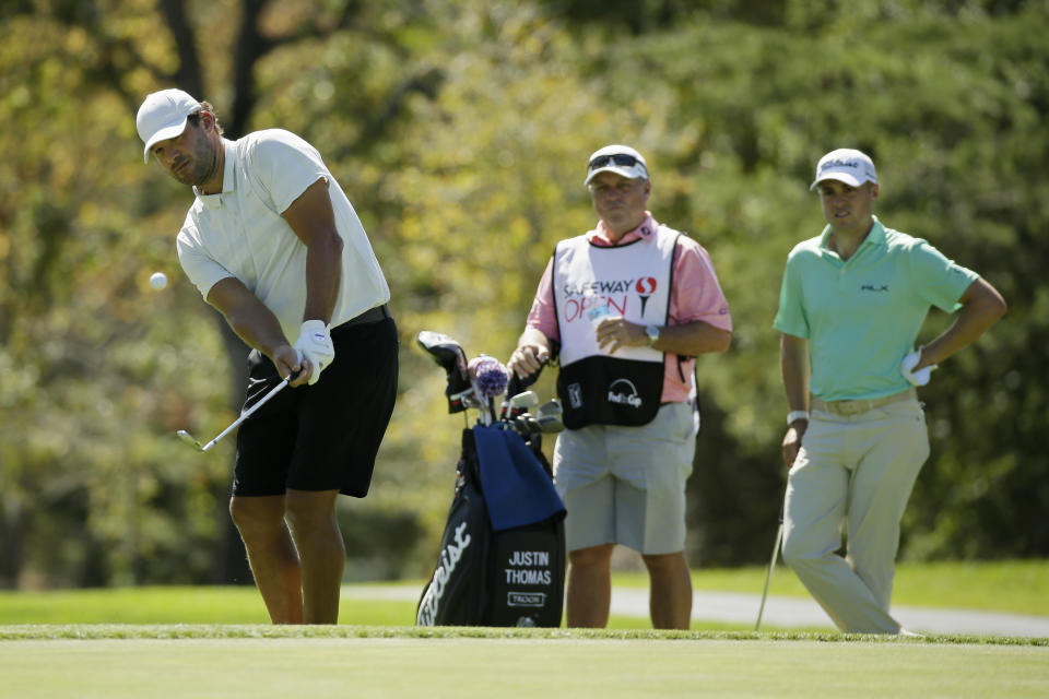 Tony Romo chips the ball onto the third green of the Silverado Resort North Course as Justin Thomas, right, looks on during the pro-am event of the Safeway Open PGA golf tournament Wednesday, Sept. 25, 2019, in Napa, Calif. (AP Photo/Eric Risberg)