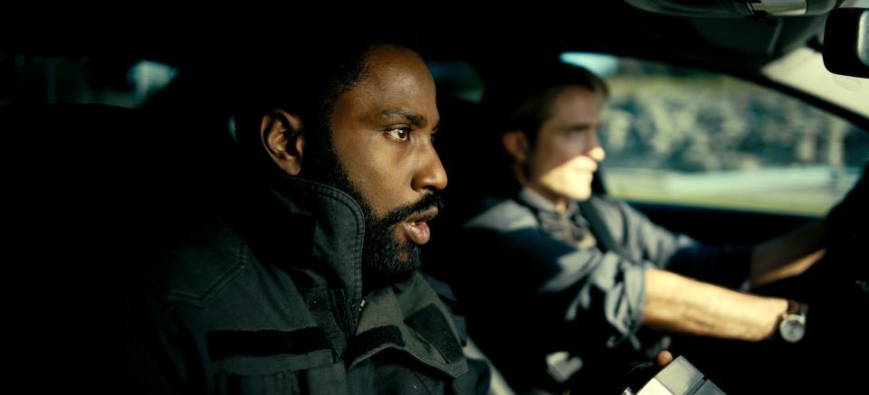 John David Washington, left, and Robert Pattinson are secret agents dealing with time inversion and an end-of-the-world scenario in Christopher Nolan's sci-fi action movie "Tenet."