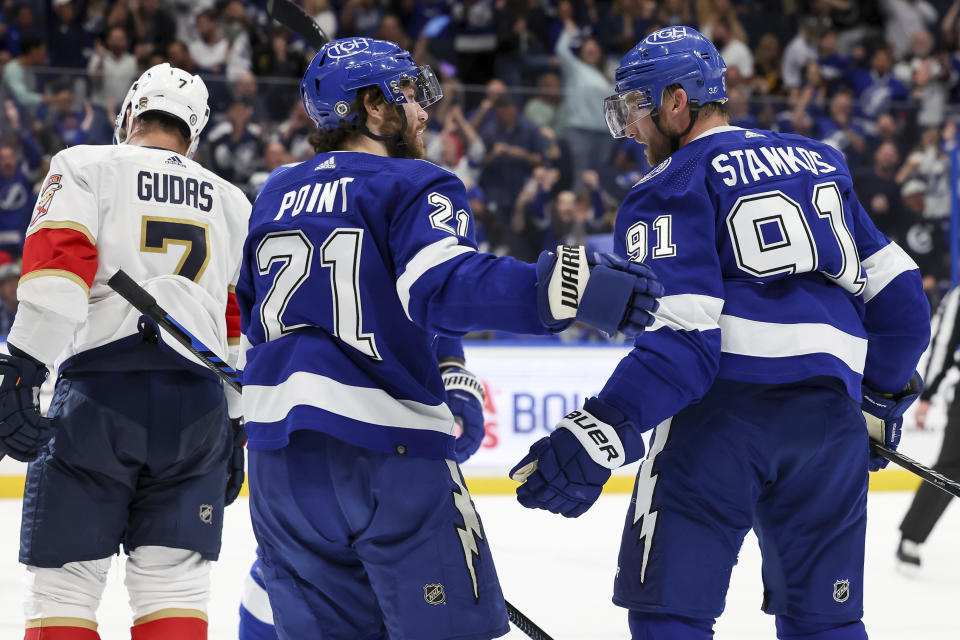 Tampa Bay Lightning's Brayden Point celebrates his goal with Steven Stamkos as Florida Panthers' Radko Gudas skates past during the second period of an NHL hockey game Tuesday, Feb. 28, 2023, in Tampa, Fla. (AP Photo/Mike Carlson)