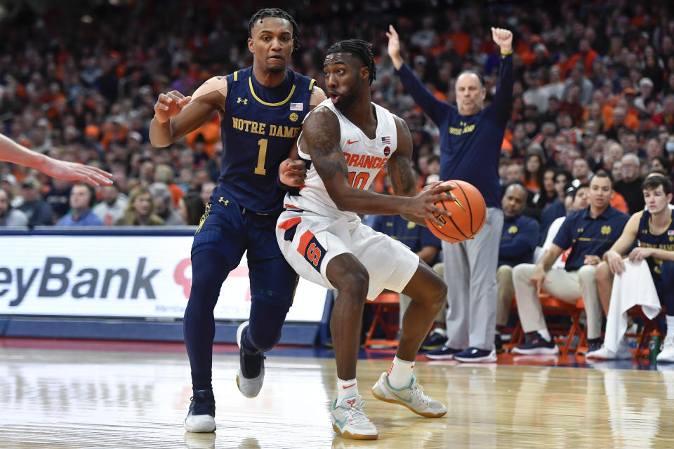 Syracuse guard Symir Torrence, right, is defended by Notre Dame guard JJ Starling during the first half of an NCAA college basketball game in Syracuse, N.Y., Saturday, Jan. 14, 2023. (AP Photo/Adrian Kraus)