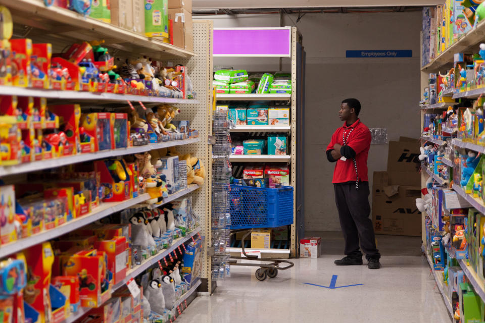 Jacoby Greer, 18, stands in a corner of Toys "R" Us to direct Black Friday shoppers in Flint, Mich. on Thursday, Nov. 22, 2012. "I'm a little nervous," Greer admitted feeling his first time working during Black Friday, "It's a lot of people." (AP Photo/Flint Journal, Griffin Moores)