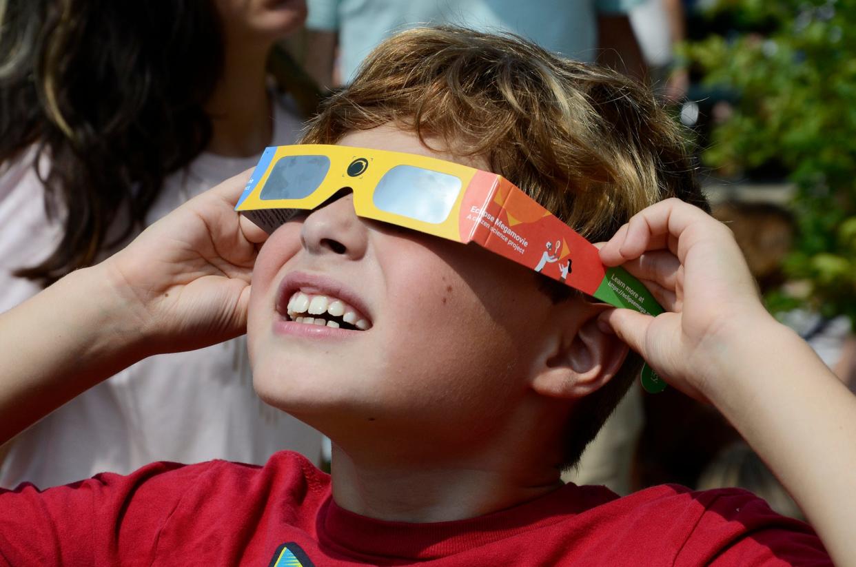 Chase Mrozinski, 8, watches the 2017 solar eclipse from the Petoskey District Library.