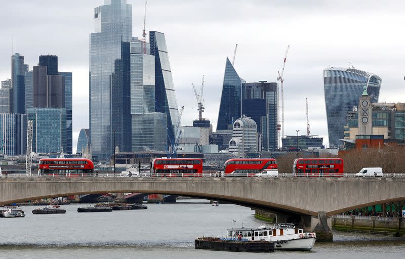 FILE PHOTO: The City of London is seen as buses cross Waterloo Bridge in London