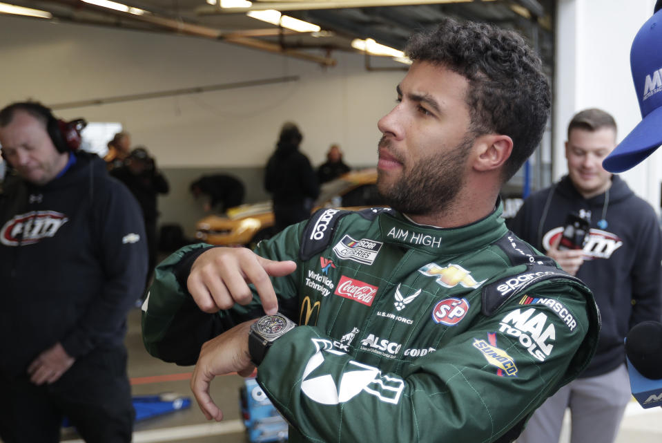 FILE - In this Feb. 14, 2020 file photo, Bubba Wallace motions to his crew about time left before getting in his car during practice for the NASCAR Daytona 500 auto race at Daytona International Speedway in Daytona Beach, Fla. (AP Photo/John Raoux, File)