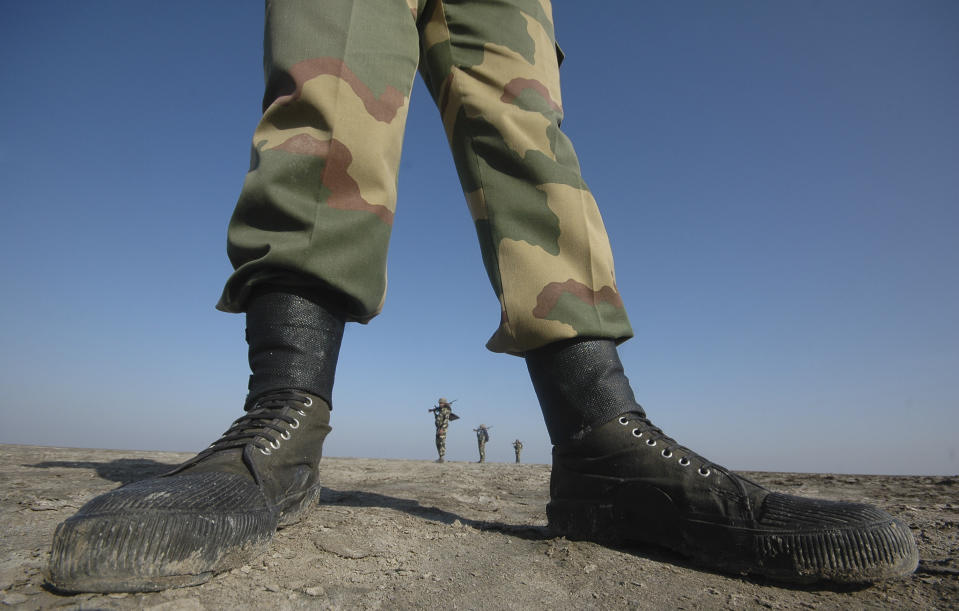 FILE - In this Nov. 25, 2009, file photo, India's Border Security Force (BSF) soldiers patrol at the border with Pakistan in Kutch district, about 550 kilometers (344 miles) from Ahmedabad, in the western Indian state of Gujarat. India's leaders are anxiously watching the Taliban takeover in Afghanistan, fearing that it will benefit their bitter rival Pakistan and feed a long-simmering insurgency in the disputed region of Kashmir, where militants already have a foothold. (AP Photo/Ajit Solanki, File)