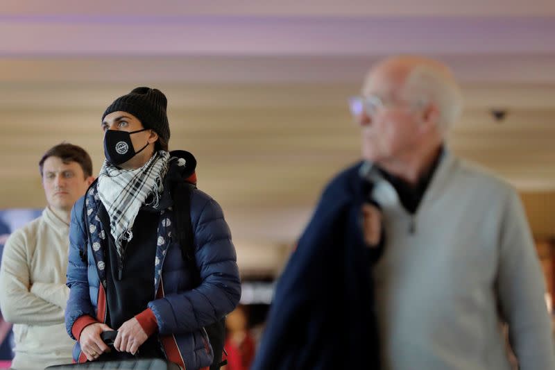 A traveler wears a mask in John F Kennedy International Airport in New York