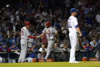 St. Louis Cardinals' Albert Pujols (5) is congratulated by third base coach Ron 'Pop' Warner after Pujols' 693rd career home run off Chicago Cubs starting pitcher Drew Smyly, right, during the seventh inning of a baseball game Monday, Aug. 22, 2022, in Chicago. (AP Photo/Charles Rex Arbogast)