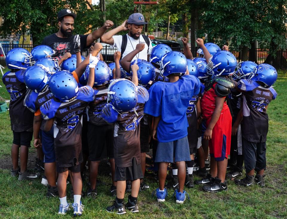 Detroit City Lions football team huddle at practice at Marygrove College in Detroit on July 29, 2021. Detroit City Lions, a youth program founded by Devon Buskin is more than a youth football program. The program offers robotics classes, volleyball, musical arts along with football and cheer. 
