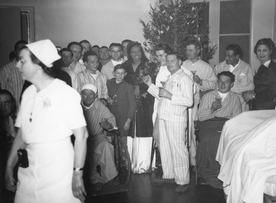 FILE - Josephine Baker with patients at a American hospital in Paris, France, where she sang for French soldiers on Christmas Day, Dec. 25, 1939. France is inducting Josephine Baker – Missouri-born cabaret dancer, French Resistance fighter and civil rights leader – into its Pantheon, the first Black woman honored in the final resting place of France's most revered luminaries. (AP Photo, File)