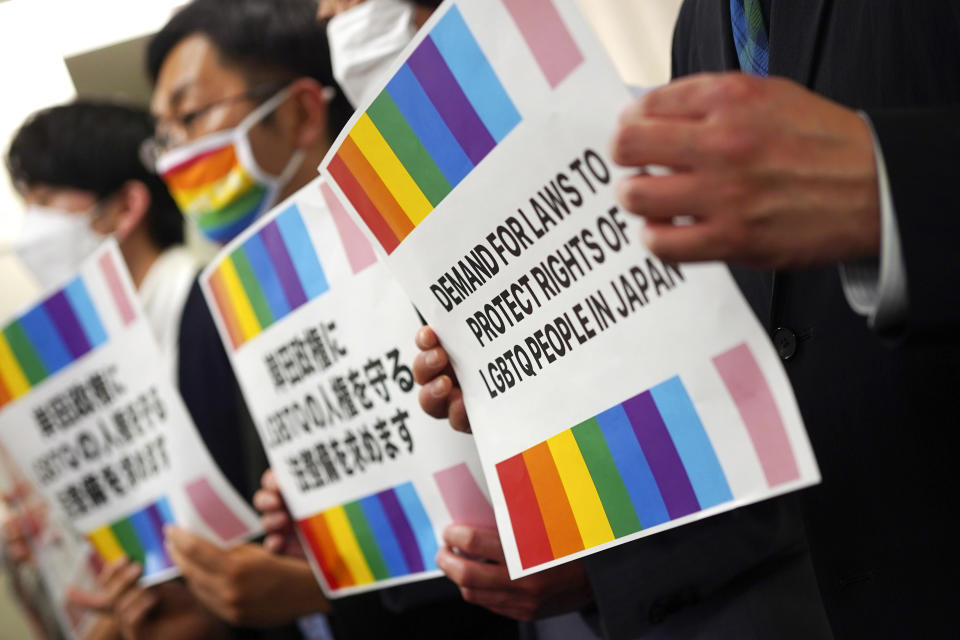 Representatives of Japanese LGBTQ people and rights groups, pose for photographers during a press conference Tuesday, Feb. 7, 2023, in Tokyo. Japanese LGBTQ people and rights groups held a news conference to protest what they say are discriminatory remarks made by top aides of Prime Minister Fumio Kishida. They demand his government enact an equality law before G-7 summit. (AP Photo/Eugene Hoshiko)