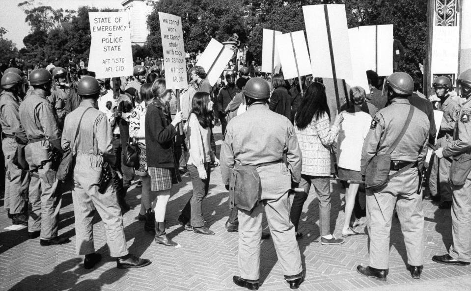 Sympathizers of a strike by minority students at the University of California, picketing at Sather Gate in Berkeley, are surrounded by police on Feb. 13, 1969. A short time later several were arrested on charges of failure to disperse. The signs they carried said they represented the American Federation of Teachers (AFT). More than 30 arrests were made on the campus on Thursday.